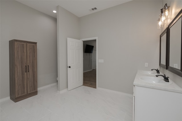 bathroom featuring vanity and toilet