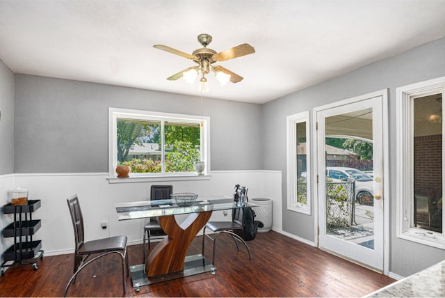 home office with ceiling fan and dark hardwood / wood-style floors