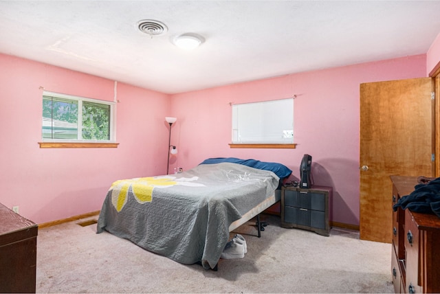 bedroom featuring light colored carpet