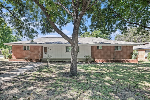 rear view of property with a yard