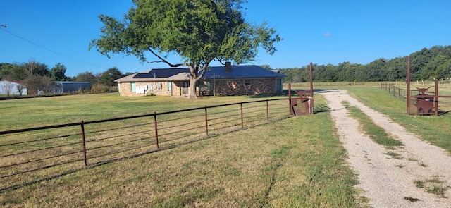 exterior space with a front lawn and a rural view