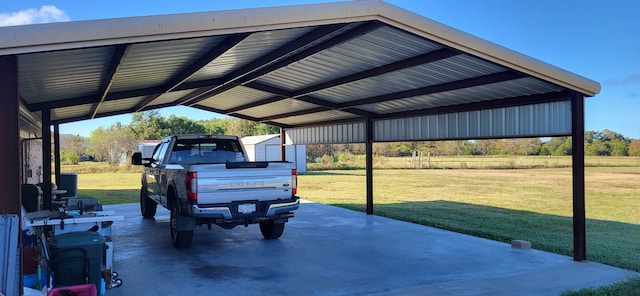 view of vehicle parking with a yard and a carport