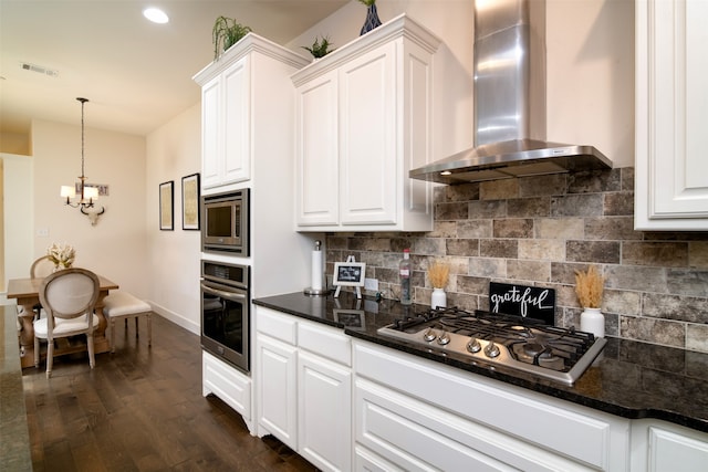 kitchen with dark wood-type flooring, wall chimney range hood, stainless steel appliances, and white cabinets