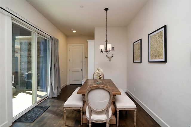 dining space featuring a notable chandelier, dark hardwood / wood-style floors, and a healthy amount of sunlight