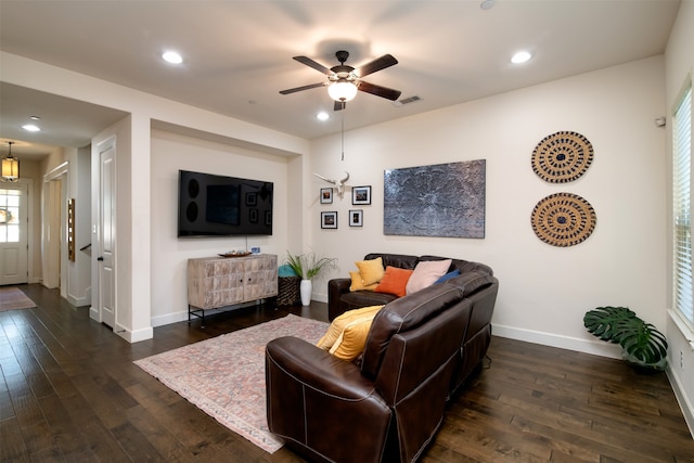 living room with ceiling fan and dark hardwood / wood-style floors