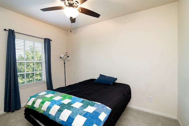 bedroom with ceiling fan and light colored carpet