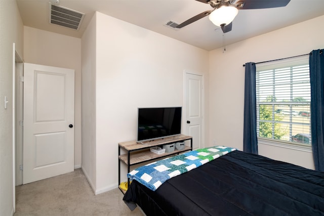 bedroom with ceiling fan and light colored carpet