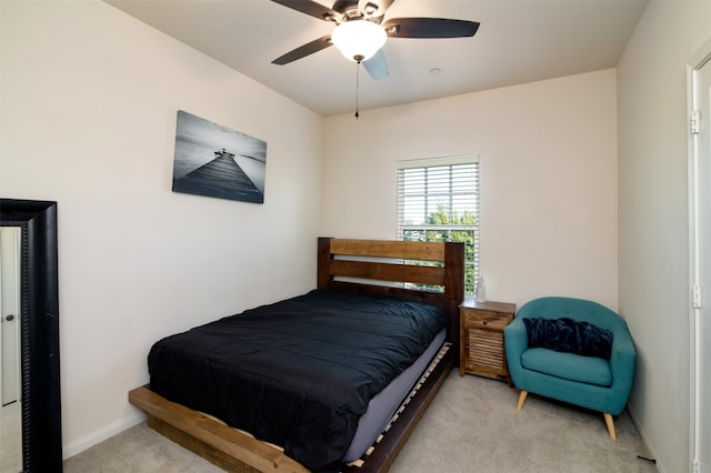 bedroom with ceiling fan and light carpet