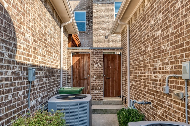 doorway to property featuring central air condition unit