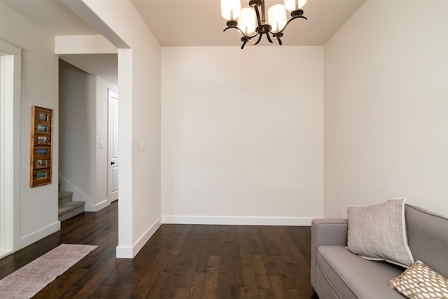 living area with dark hardwood / wood-style flooring and a chandelier