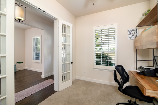 home office with french doors and hardwood / wood-style floors