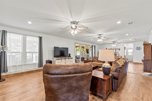 living room featuring light wood-type flooring and ornamental molding