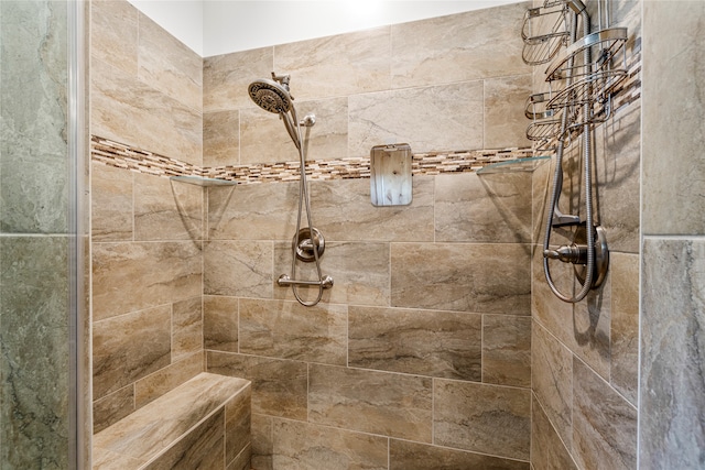 bathroom with a tile shower