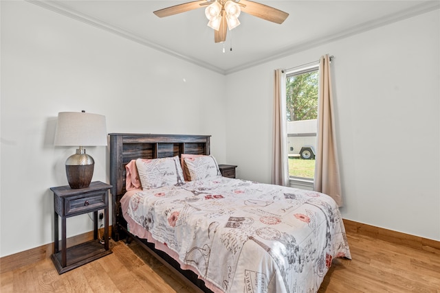 bedroom with wood-type flooring, crown molding, and ceiling fan