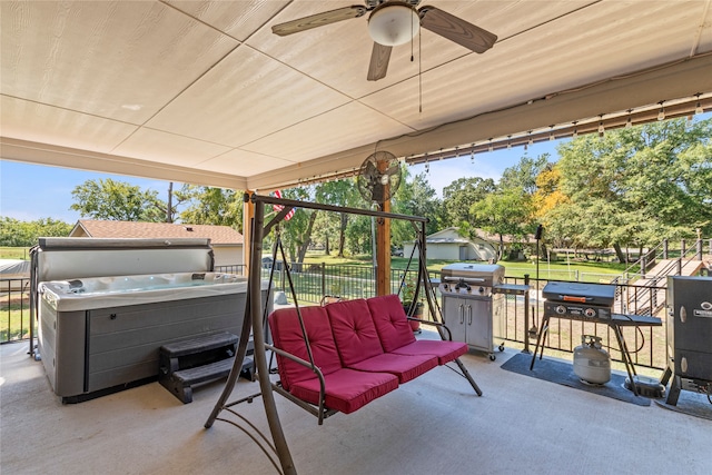 view of patio featuring ceiling fan, grilling area, and a hot tub