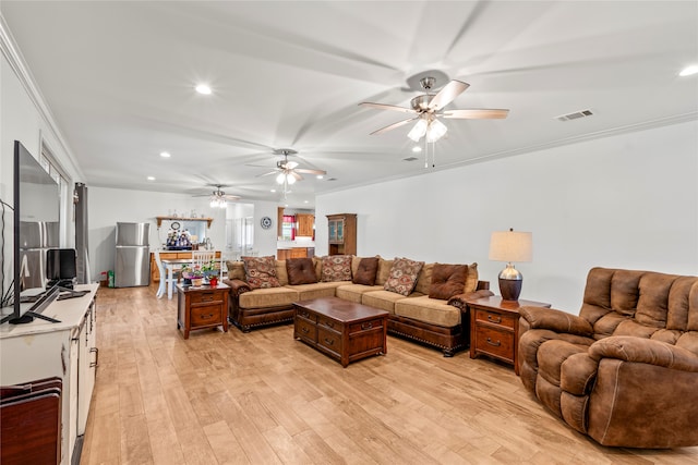 living room with light wood-type flooring, crown molding, and ceiling fan