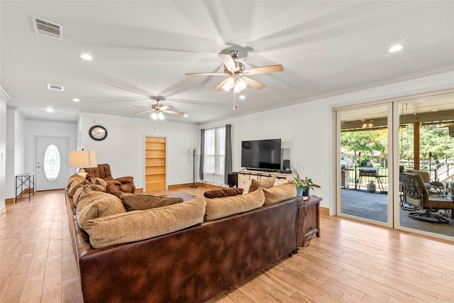 living room with light wood-type flooring, crown molding, and ceiling fan