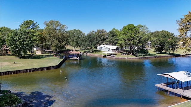 dock area with a water view and a yard