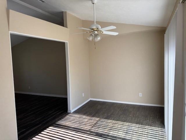 spare room featuring ceiling fan, dark hardwood / wood-style flooring, and lofted ceiling