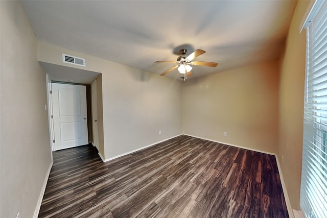 unfurnished room featuring ceiling fan and dark wood-type flooring