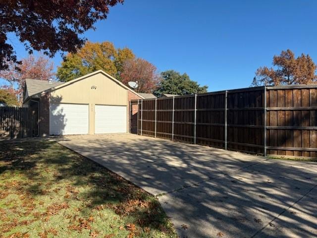 view of side of home with a garage and an outbuilding