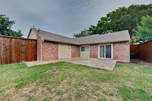 back of property with a patio area and a yard