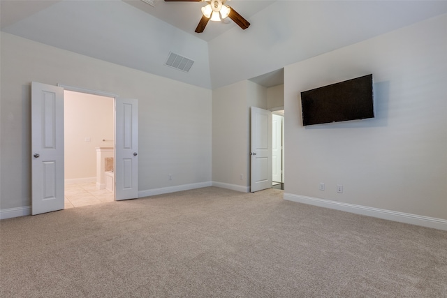 unfurnished bedroom featuring ceiling fan, light carpet, and high vaulted ceiling