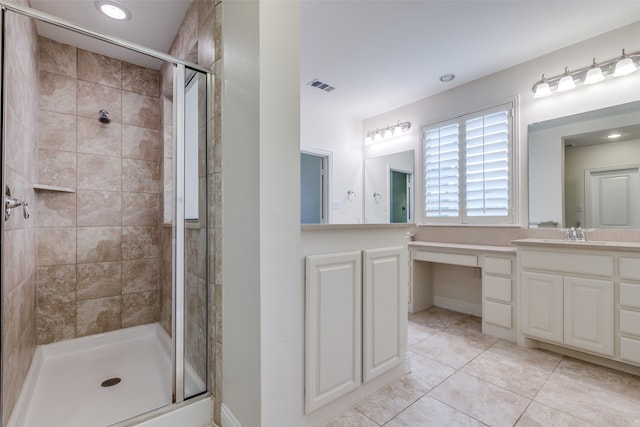 bathroom with tile patterned flooring, a shower with door, and vanity