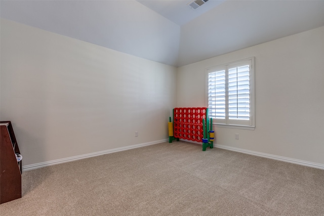 interior space with lofted ceiling and light carpet