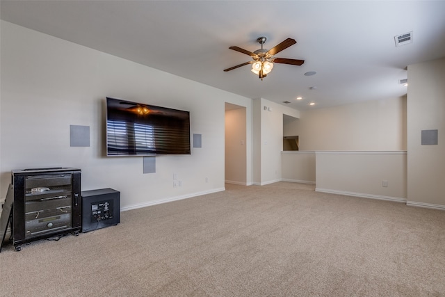 carpeted living room featuring ceiling fan