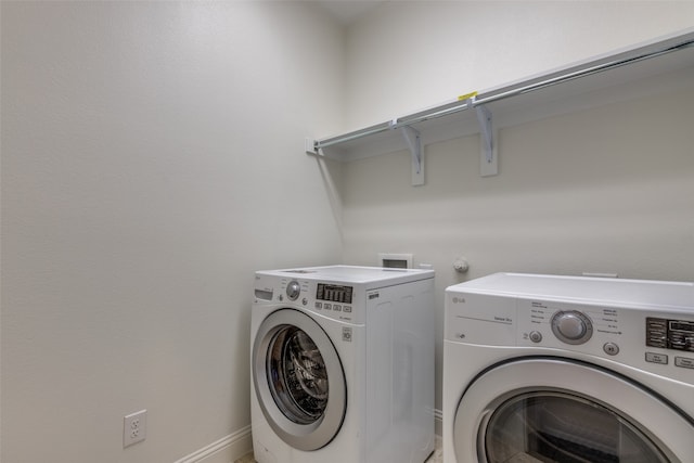 clothes washing area featuring washer and dryer