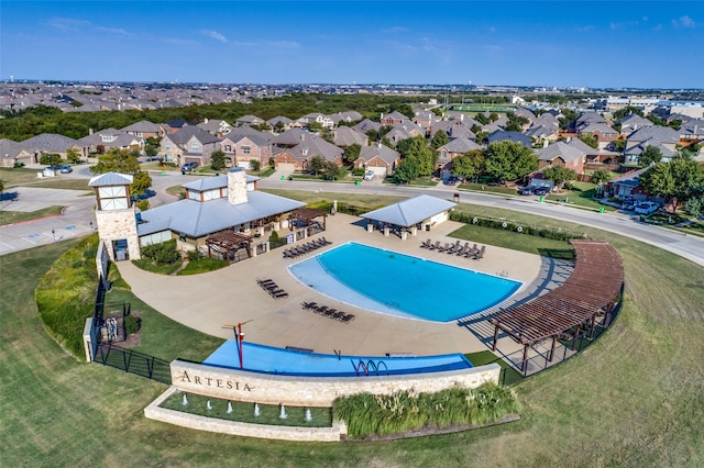 view of pool featuring a lawn