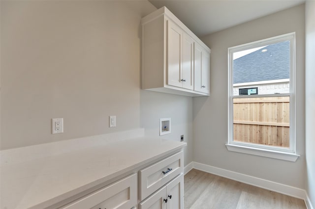 clothes washing area with hookup for a washing machine, light hardwood / wood-style flooring, cabinets, and hookup for an electric dryer