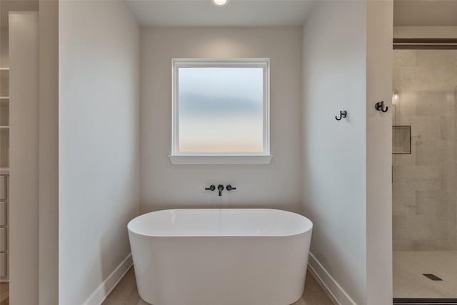 bathroom featuring hardwood / wood-style flooring and shower with separate bathtub