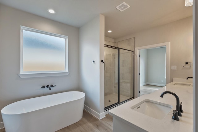 bathroom featuring vanity, wood-type flooring, and independent shower and bath