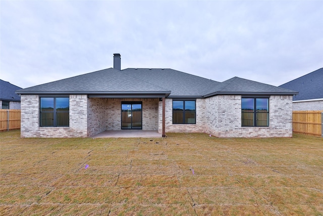 back of property featuring a yard and a patio