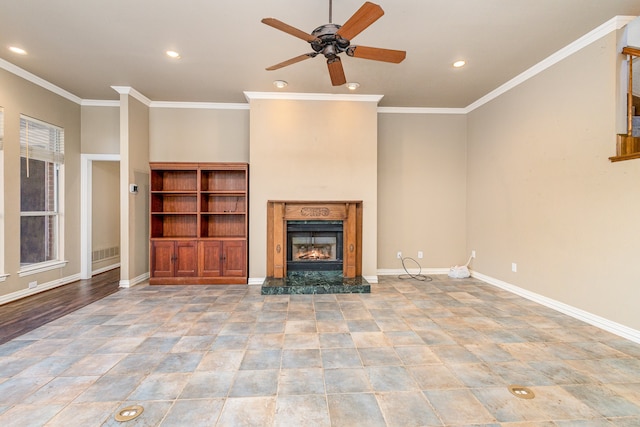 unfurnished living room featuring ceiling fan, a premium fireplace, and ornamental molding