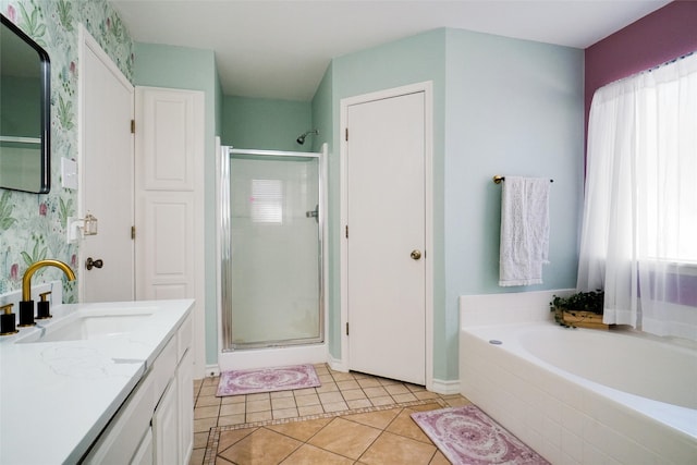 bathroom with tile patterned flooring, vanity, and plus walk in shower