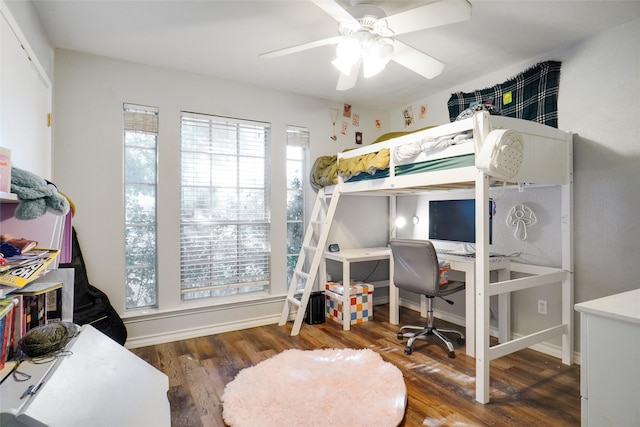 bedroom with dark hardwood / wood-style floors and ceiling fan