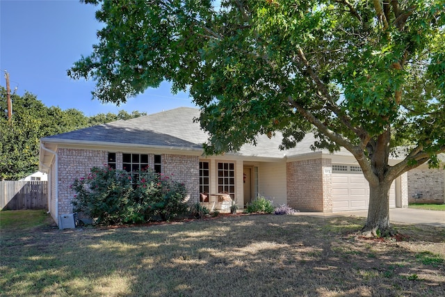 single story home featuring a garage and a front lawn