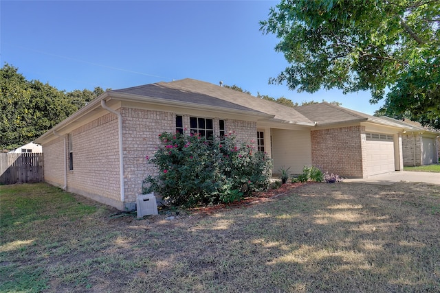 single story home featuring a front yard and a garage