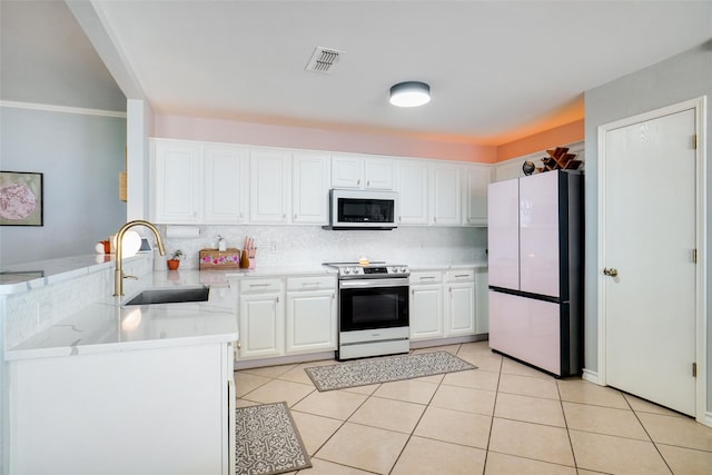 kitchen with white refrigerator, kitchen peninsula, sink, white cabinetry, and electric range