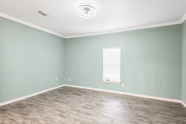 empty room with wood-type flooring and crown molding