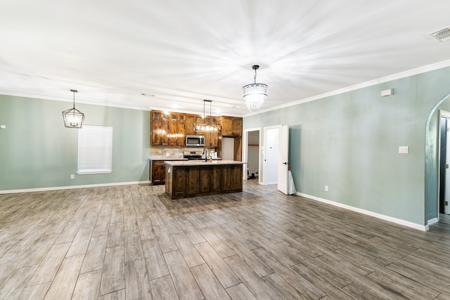 kitchen featuring pendant lighting, appliances with stainless steel finishes, and dark hardwood / wood-style flooring