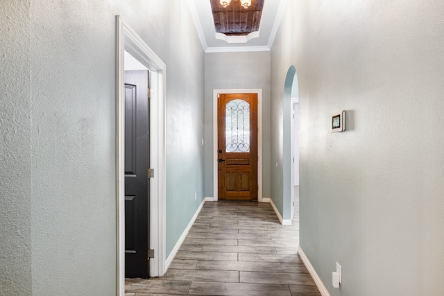 entryway featuring hardwood / wood-style flooring and crown molding