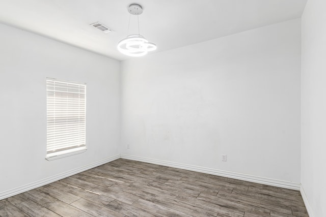 spare room with hardwood / wood-style flooring