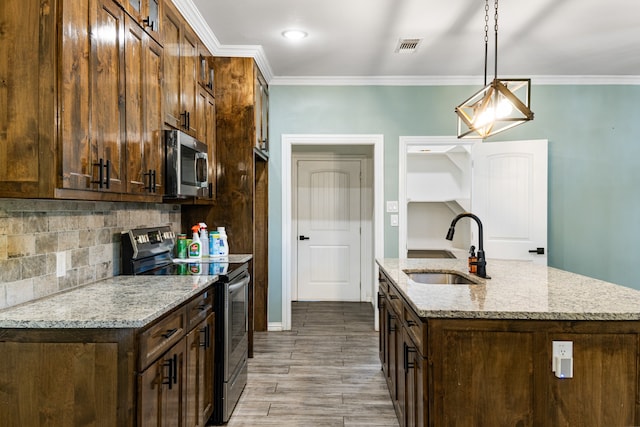 kitchen with light hardwood / wood-style floors, sink, hanging light fixtures, stainless steel appliances, and light stone countertops