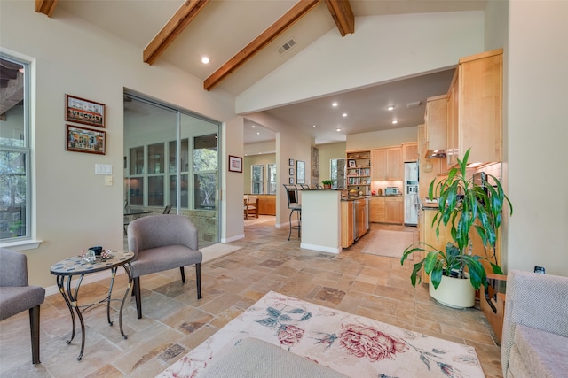 interior space with high vaulted ceiling and beamed ceiling