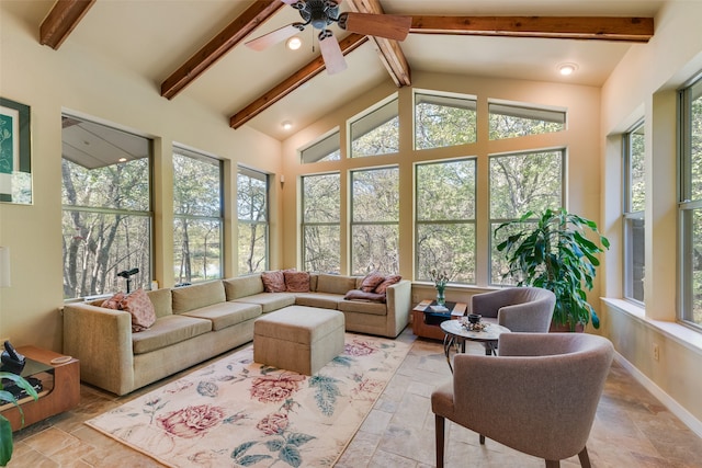 sunroom featuring a healthy amount of sunlight, lofted ceiling with beams, and ceiling fan