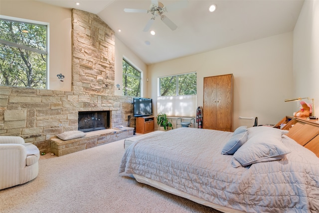 carpeted bedroom with ceiling fan, high vaulted ceiling, and a fireplace